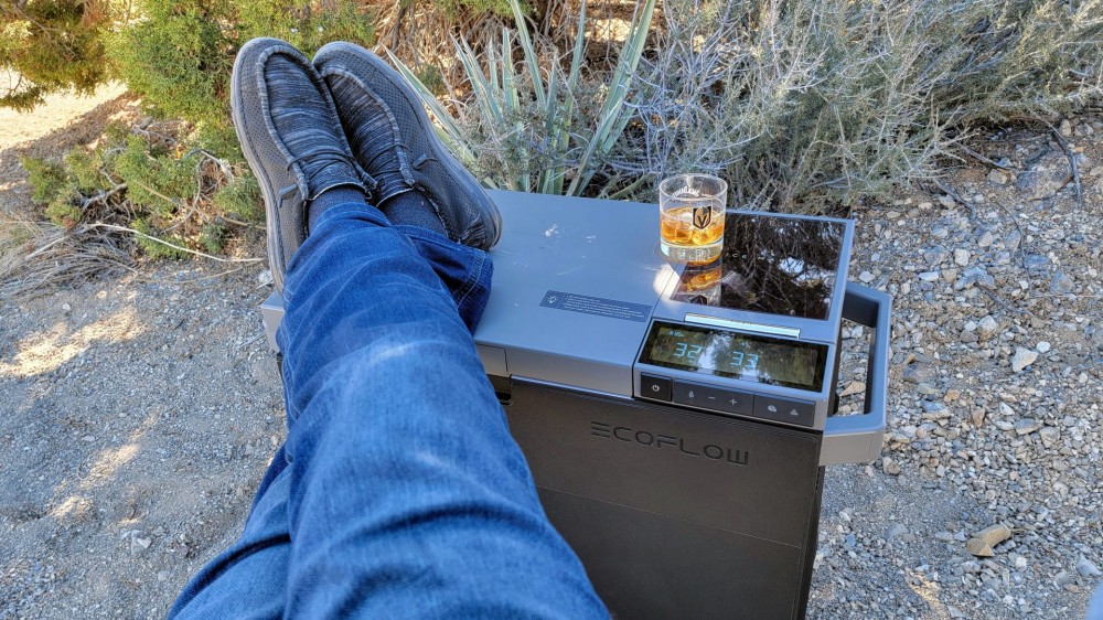 Man putting his feet up on a cooler lid.