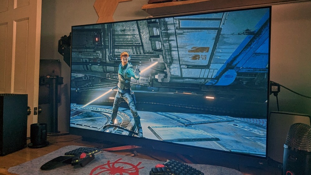 A gaming monitor showing a lightsaber